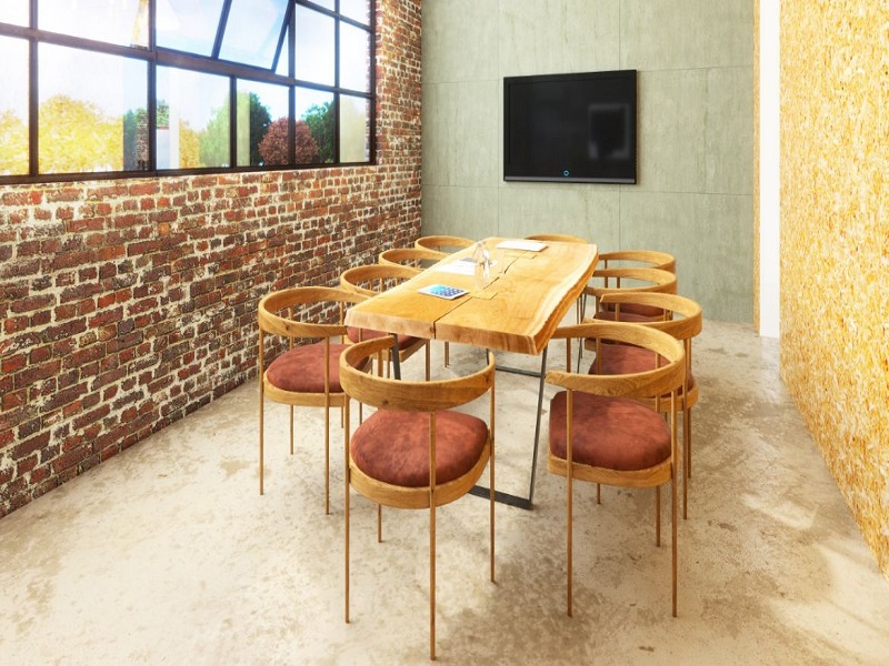 Industrial Boardroom Setting with Brick Walls and a Wooden Boardroom Table with Wooden Chairs